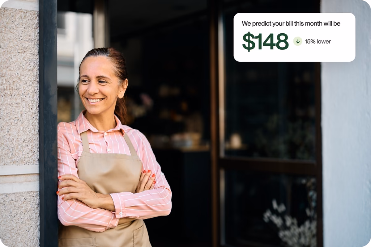 A smiling shop owner in her doorway, with a callout predicting a $148 bill that is 15% lower
