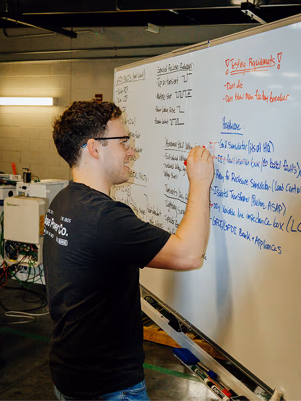 A Base engineer mapping out a problem on a whiteboard
