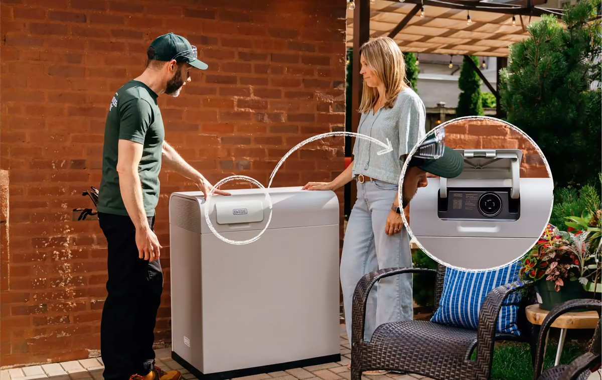 A Base technician and a homeowner beside a Core battery, with the generator recharge port highlighted