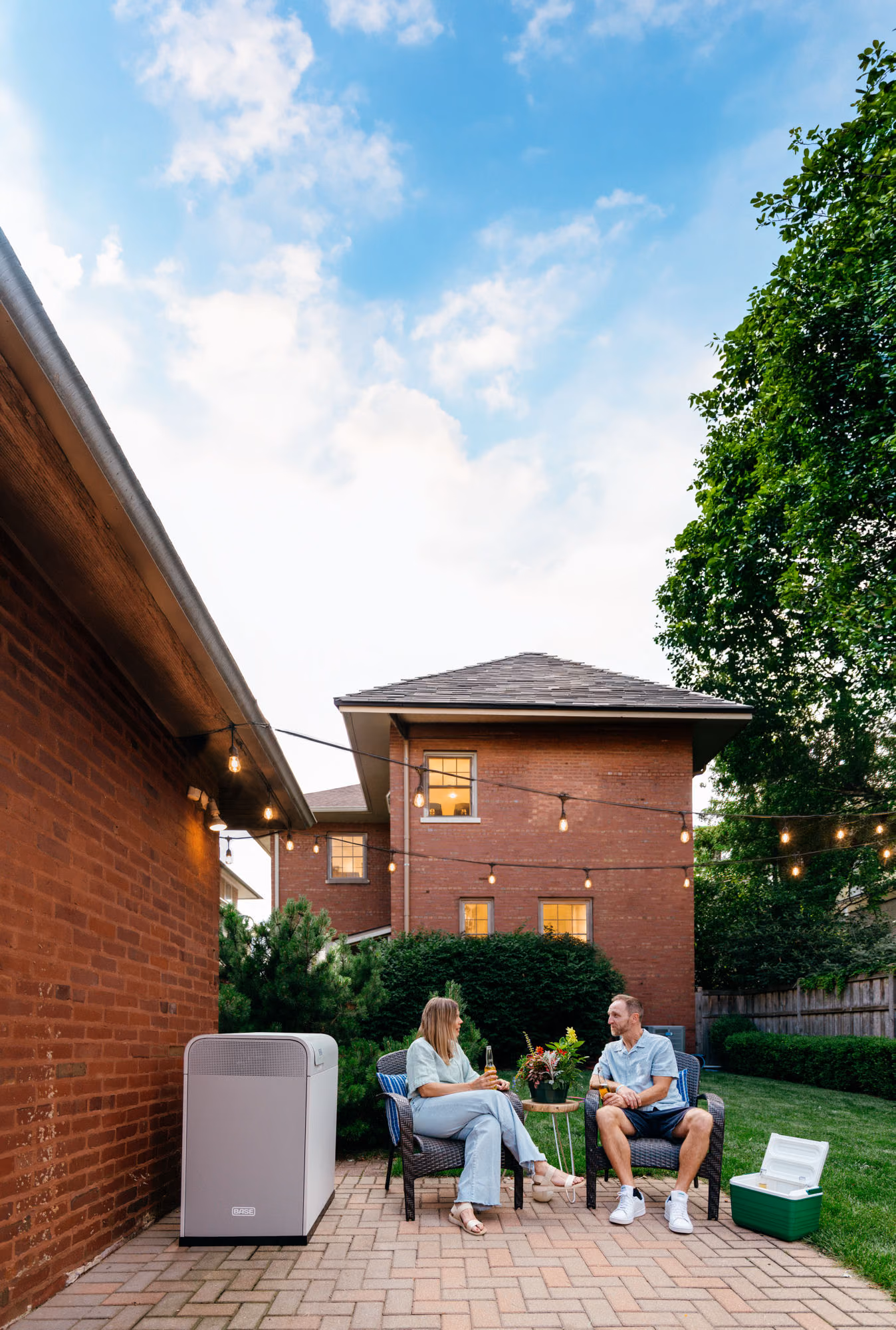 An Illinois couple relaxing in their backyard beside a Base battery