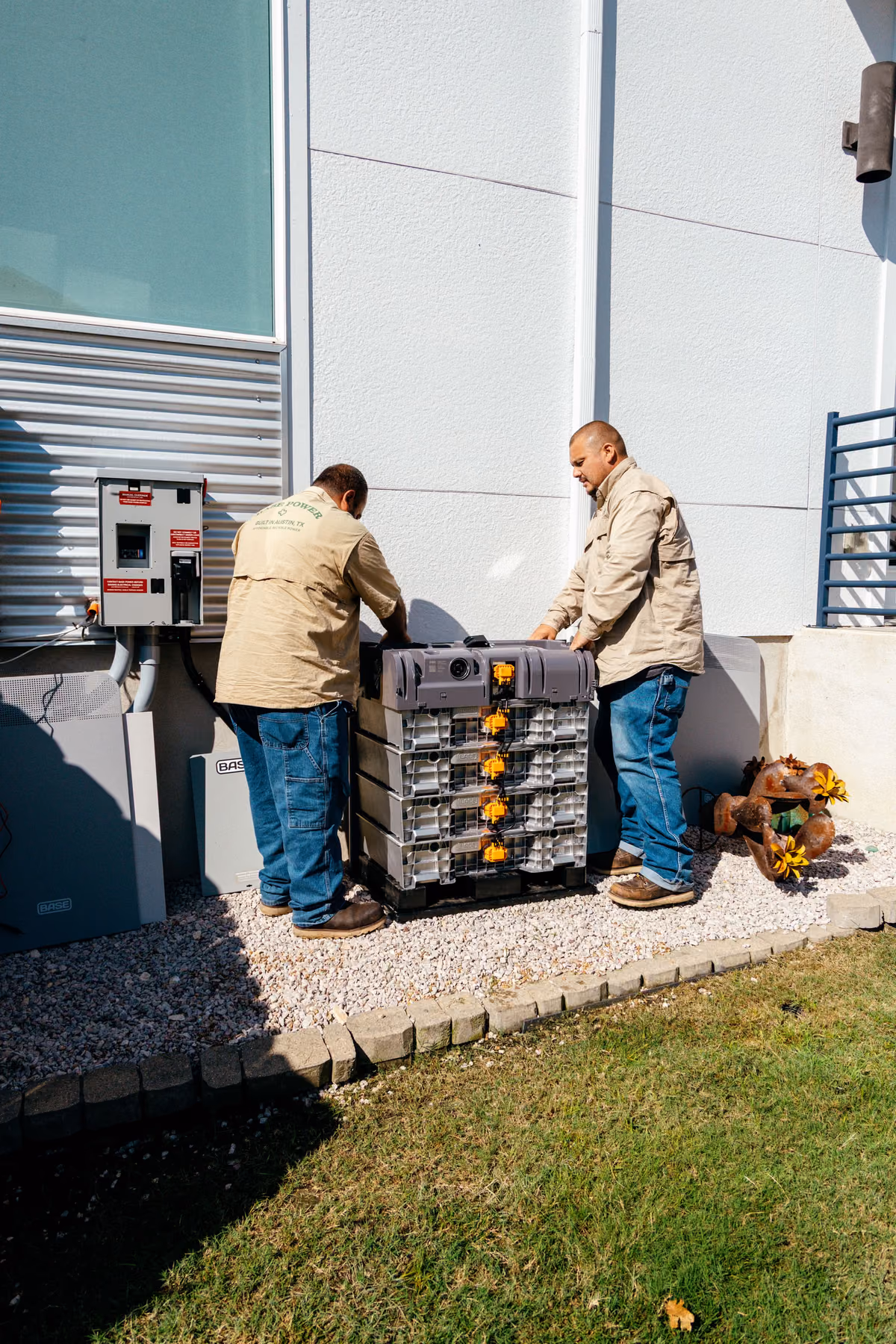 Two Base electricians working through a battery install together