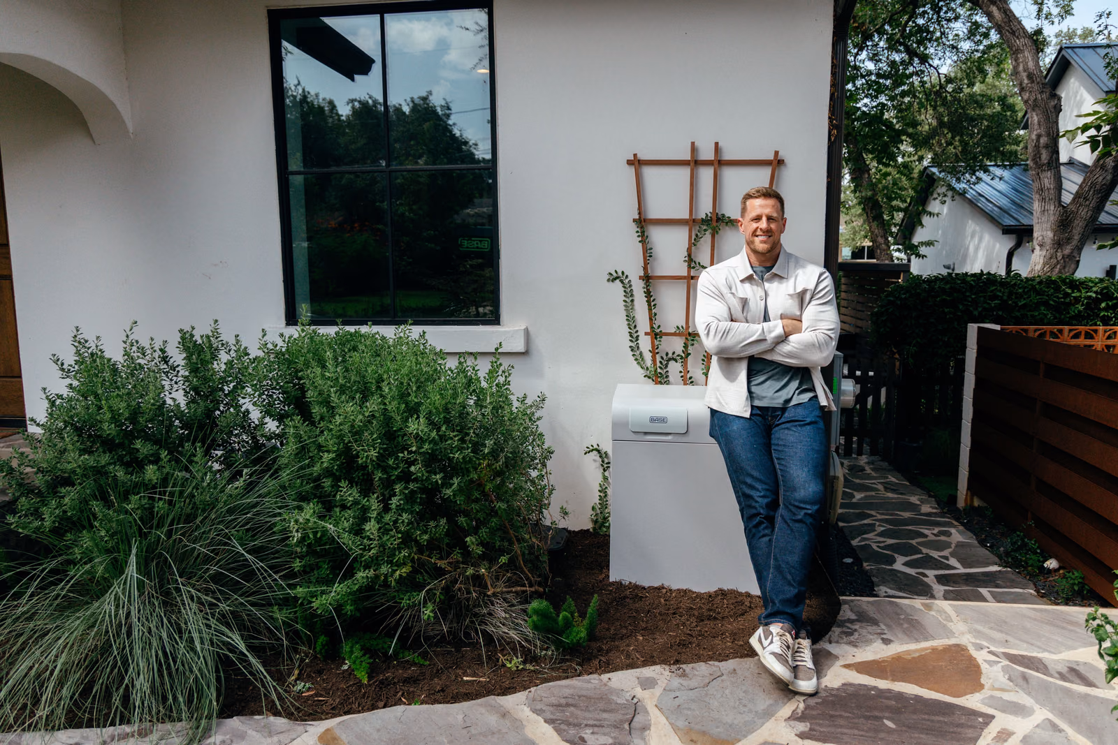 JJ Watt standing beside the Base battery at his home