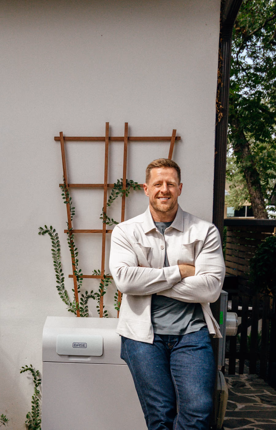 JJ Watt leaning against a Base battery outside his home