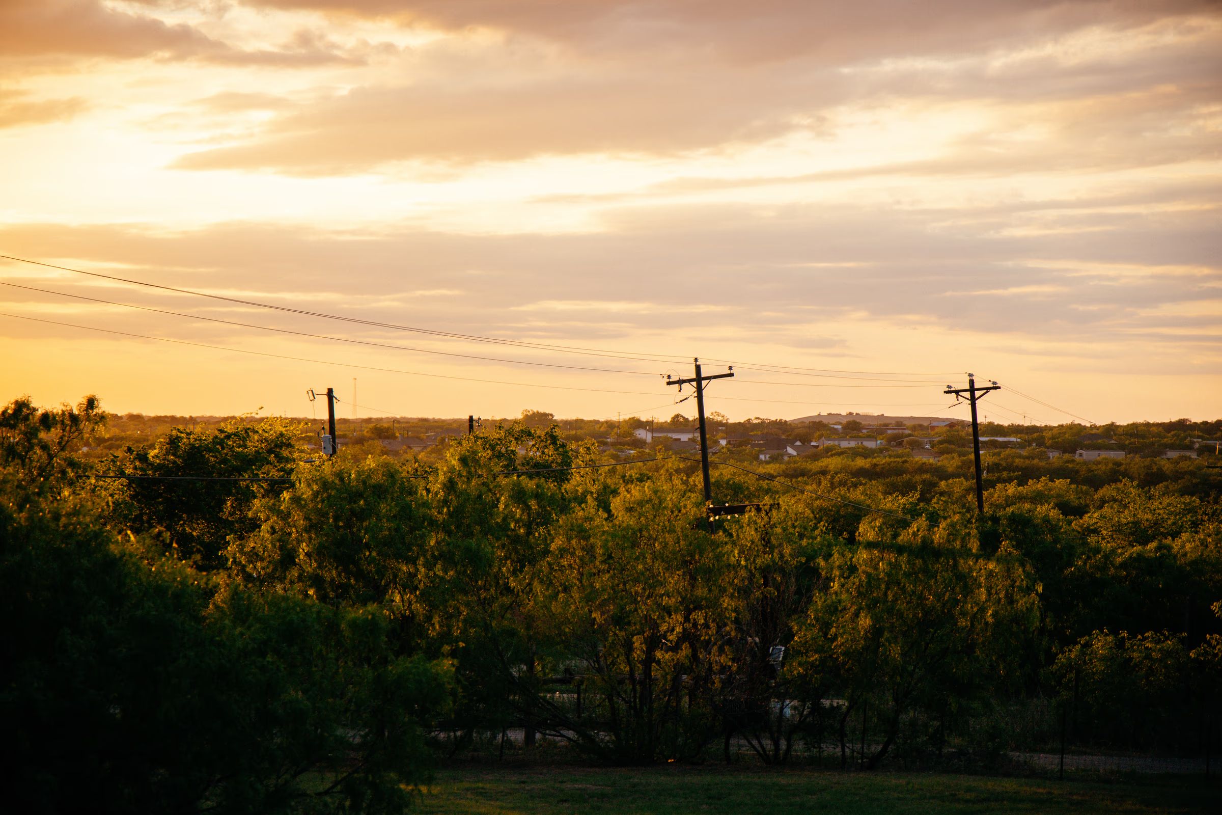 Power lines over rural Texas at sunset